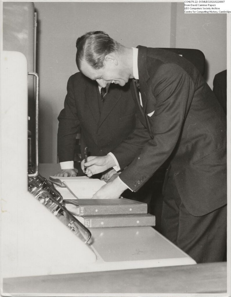 Prince Philip signing the visitors book for David Caminer at LEO's computer works and factory on Minerva Road in Acton, London 22 March 1960